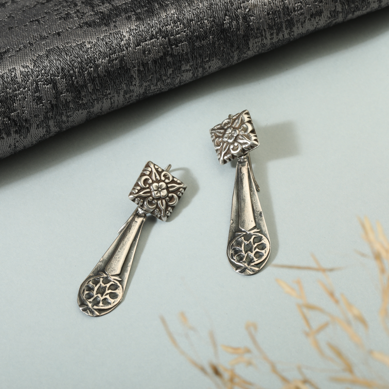 925 Silver Armor Earrings displayed as prop image on festive background – trendy silver earrings with fine detailing.