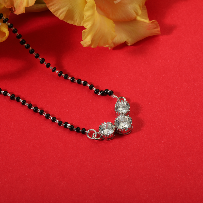 925 Silver Auspicious Alliance Mangalsutra displayed on red festive background – traditional yet modern silver mangalsutra jewelry.