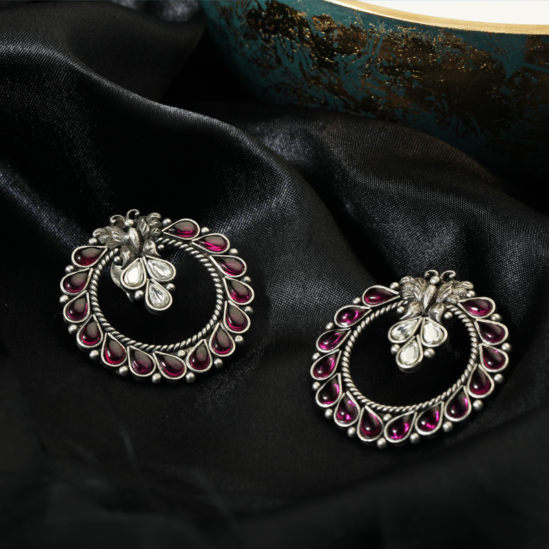 925 Silver Butterfly Earrings with pink stone displayed as prop image on festive background – trendy silver earrings with fine detailing