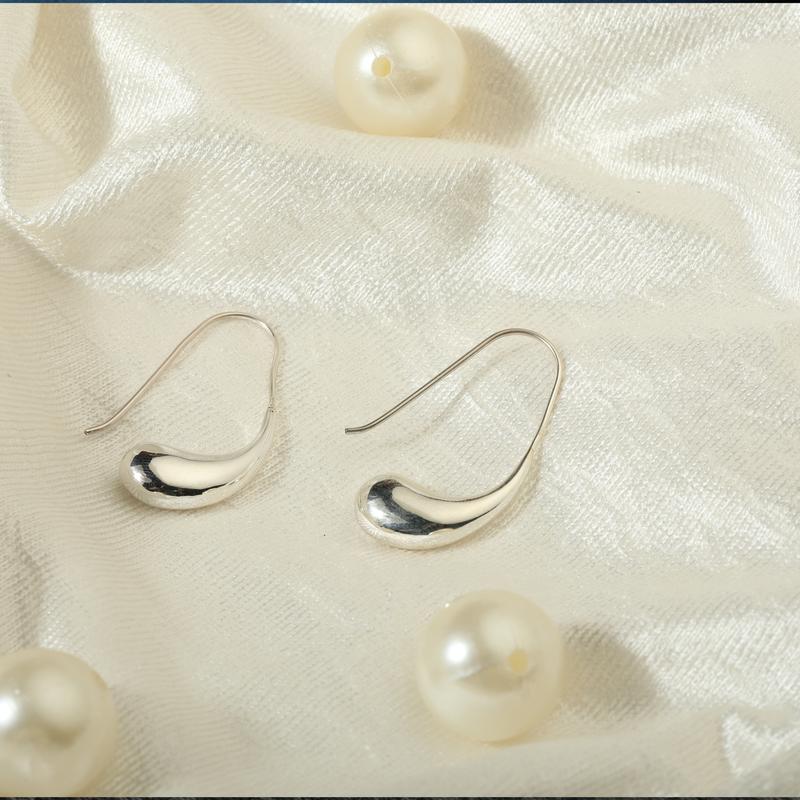 925 Silver Cashew Nut Earrings displayed as prop image on festive background – stylish silver earrings with fine detailing.