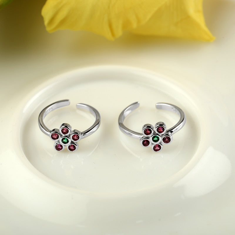 925 silver enamel flower toe ring displayed with props – floral silver accessory