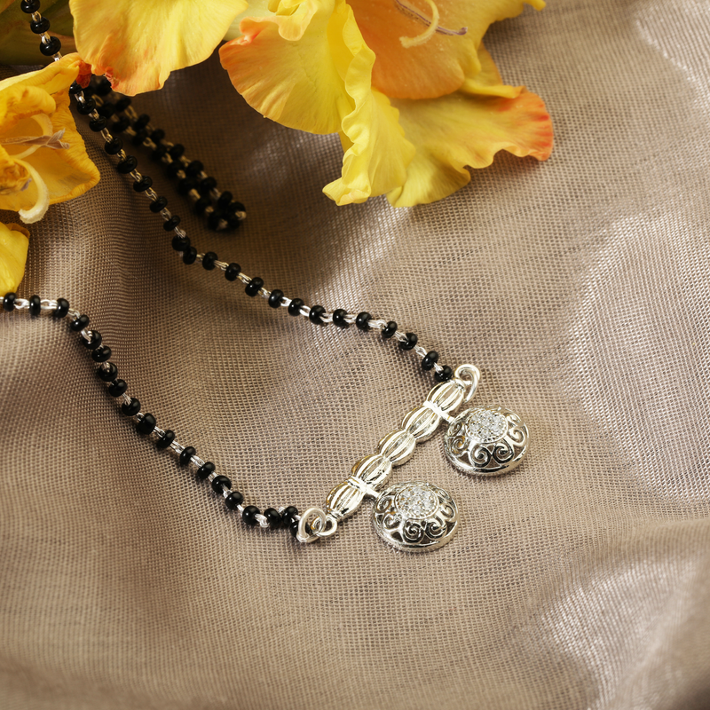 925 Silver Flame of Destiny Mangalsutra displayed with flowers – perfect silver mangalsutra gift for wife or anniversary