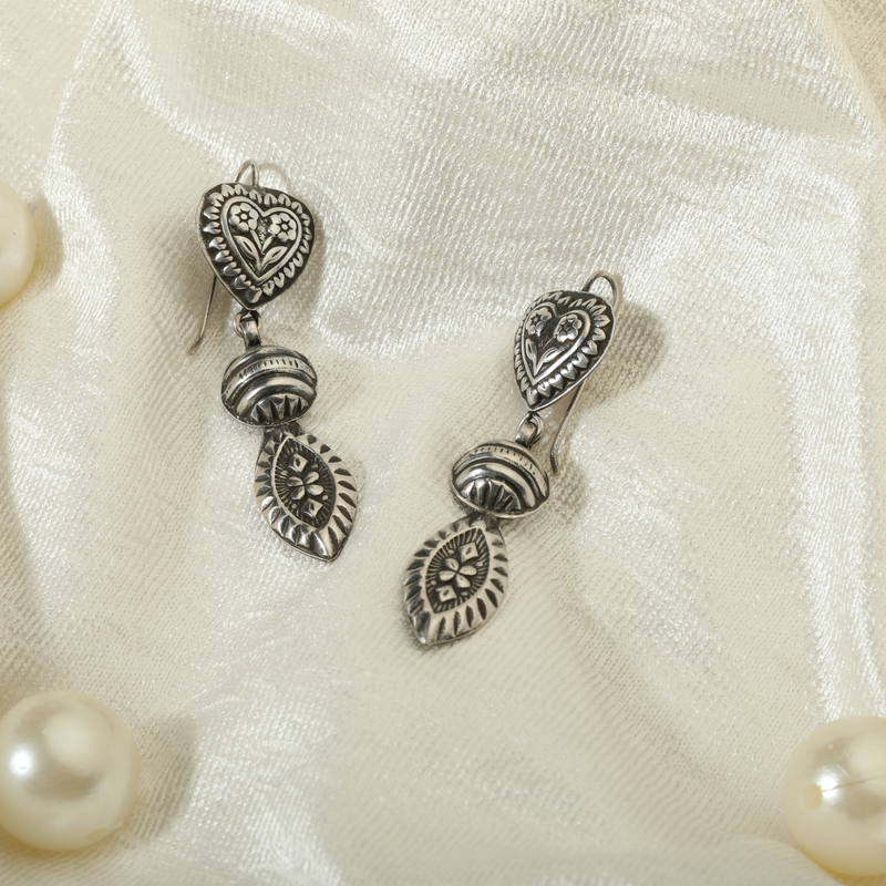 925 Silver Heart & Leaf Earrings displayed as prop image on festive background – trendy silver earrings with fine detailing