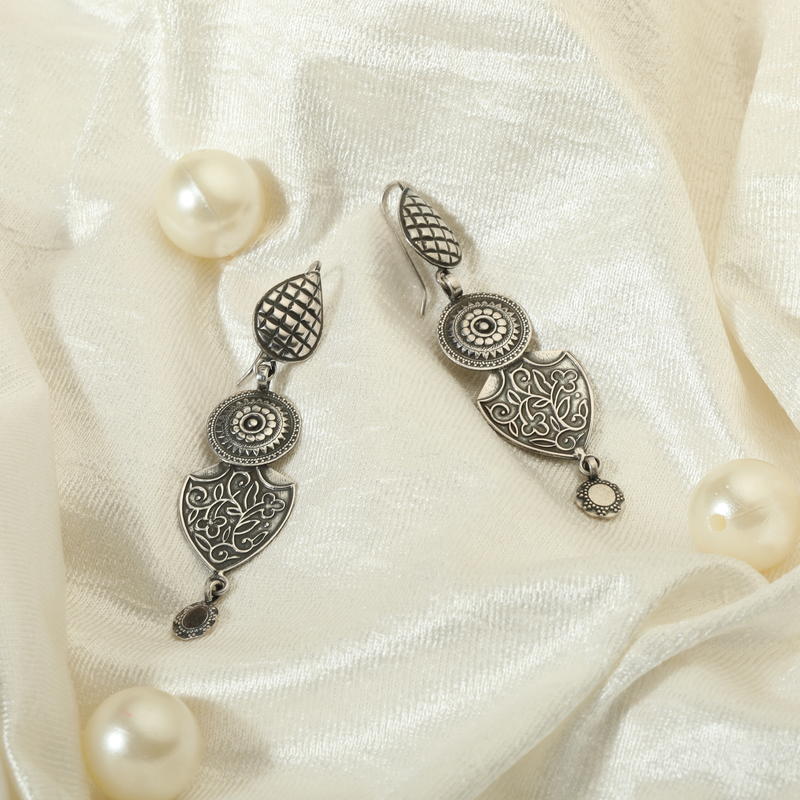 925 Silver Intricate Tribal Earrings displayed as prop image on festive background – traditional silver earrings with fine detailing