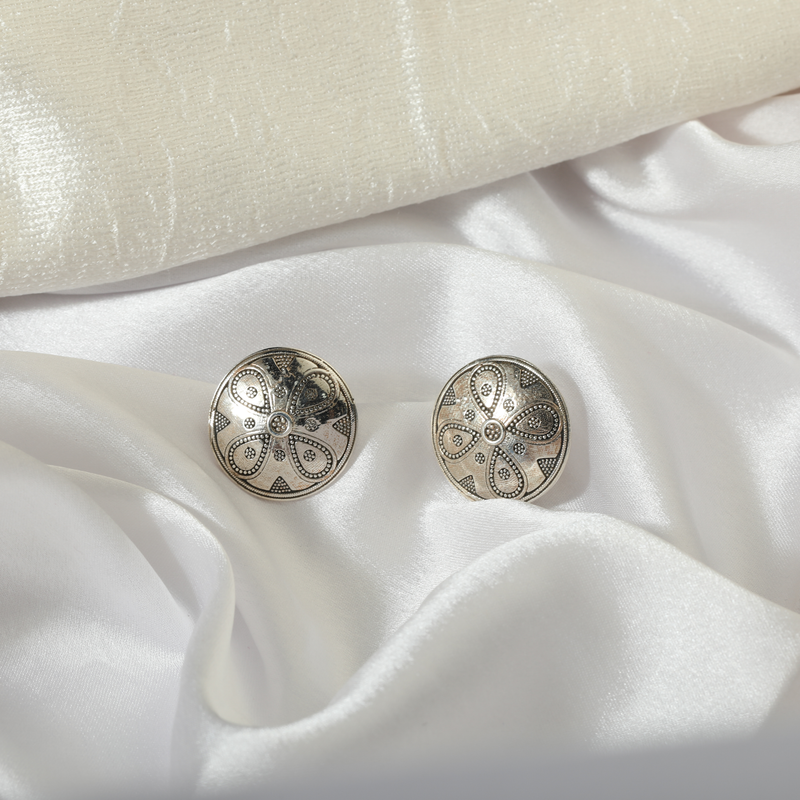 Close-up of 925 Silver Leaf Stud Earrings displayed on soft fabric background