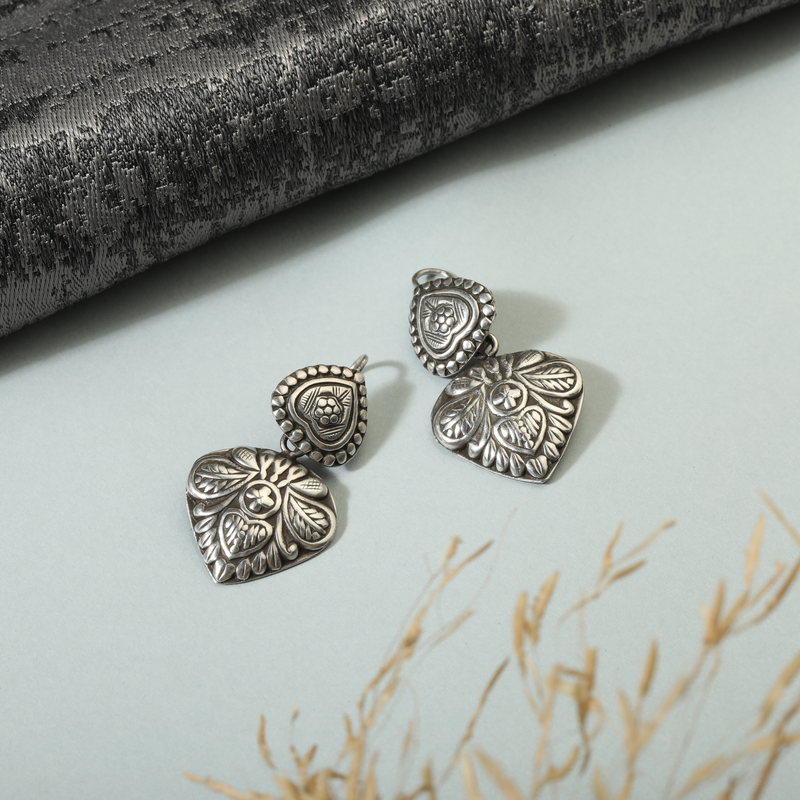 925 Silver Love Earrings displayed as prop image on festive background – stylish silver earrings with fine detailing.