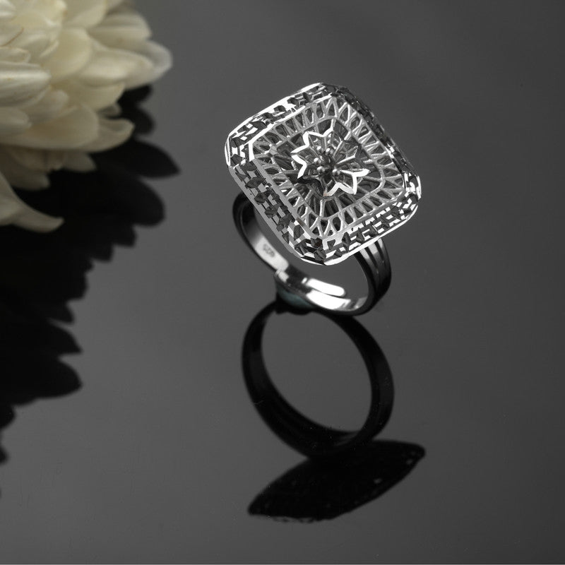 925 silver spinner ring with web design displayed with props – unique silver accessory