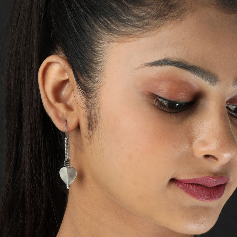 Woman wearing 925 Silver Spiral Heart Earrings – romantic and stylish look