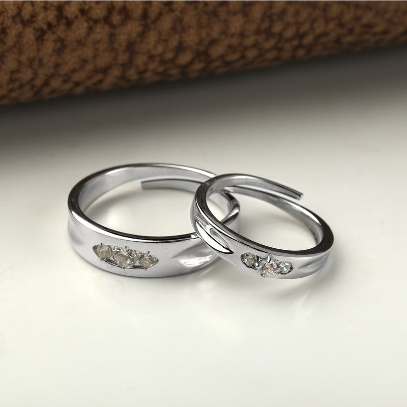 925 silver three stone couple rings displayed with props – romantic silver accessory set