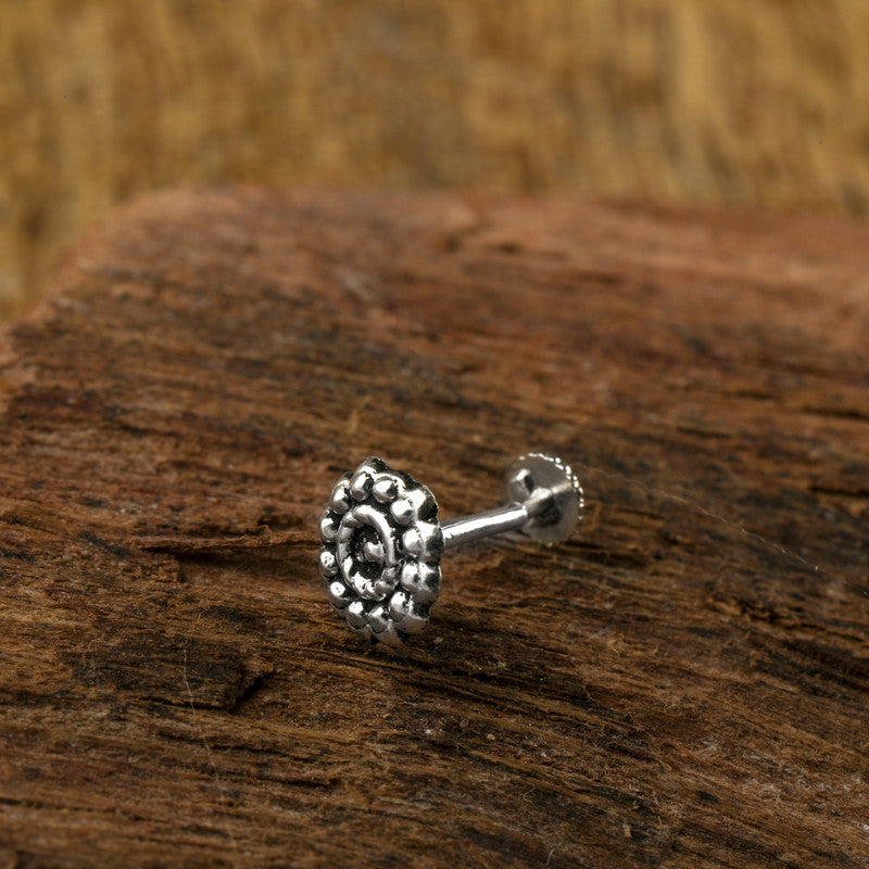 Close-up of 925 Sterling Silver Circle Nose Stud placed on dark fabric surface