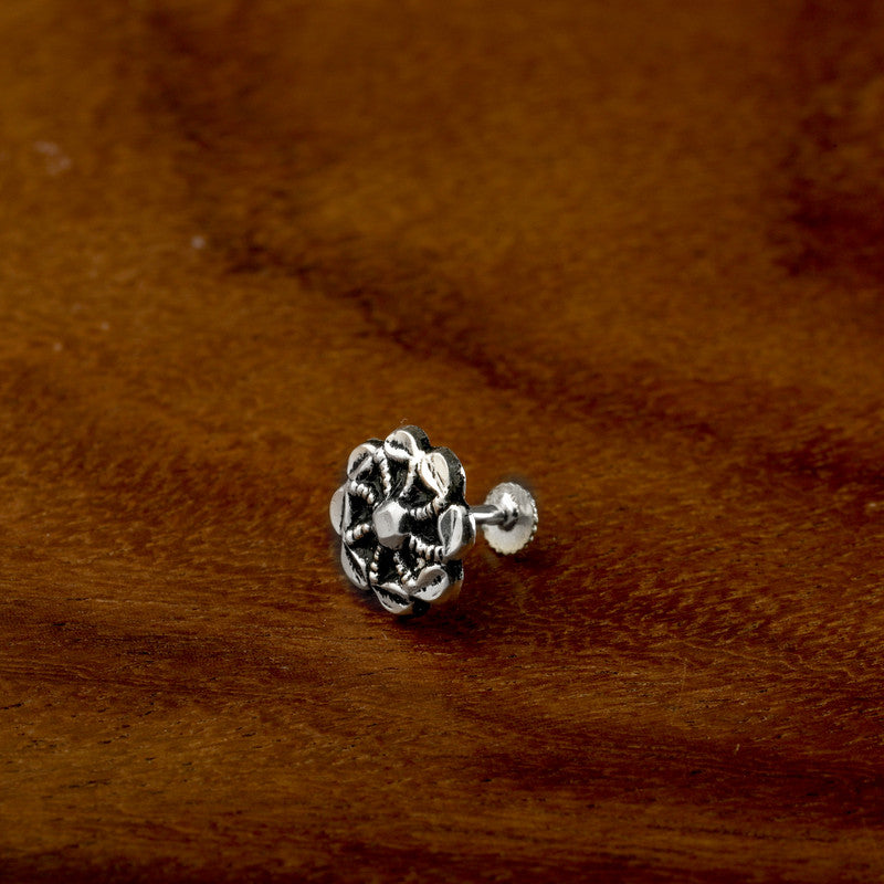 925 sterling silver fan-shaped nose pin on wooden surface – traditional silver nose accessory