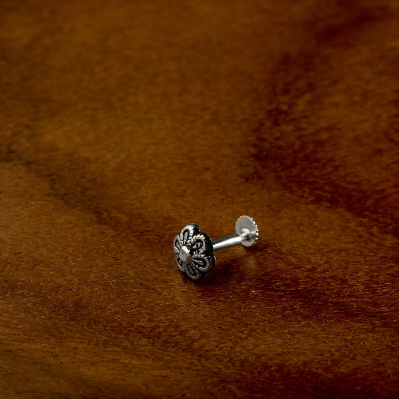 925 sterling silver flower nose stud on wooden surface – traditional silver nose accessory