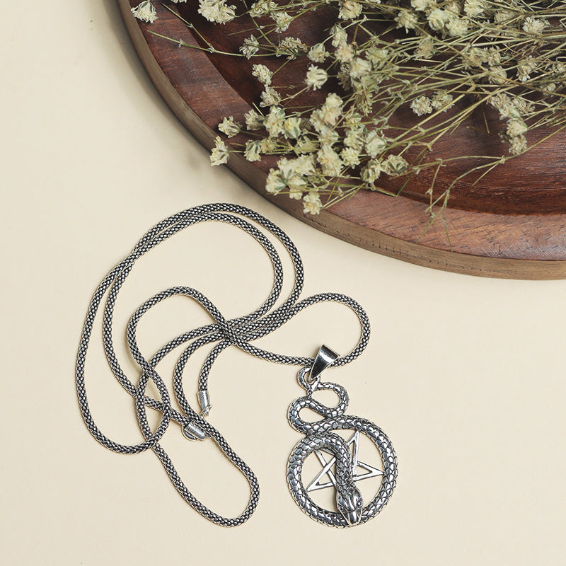 Men’s 925 Sterling Silver Star and Snake Pendant with Detailed Symbol Design displayed on surface