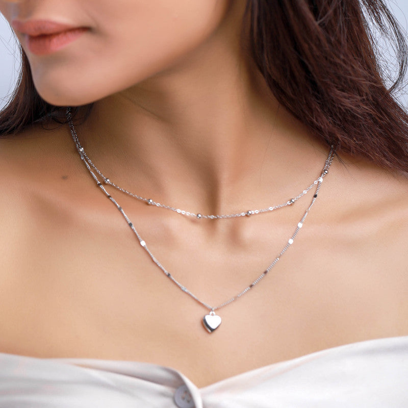 Woman wearing 925 silver double heart necklace — stylish silver jewelry gift for festivals.