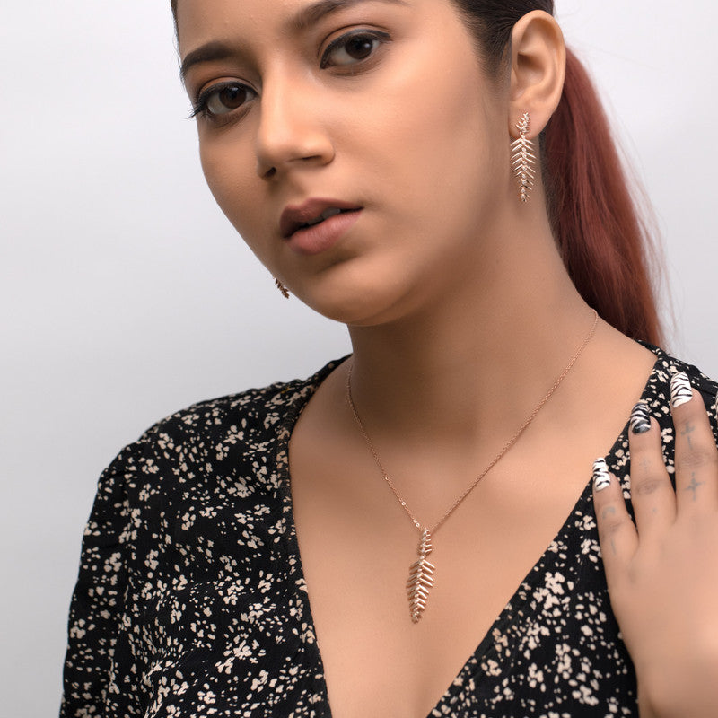 Woman wearing a silver fern pendant set, adding charm and beauty to her festive celebration look.