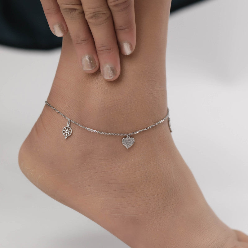 Woman styled in silver hanging heart anklet, chic jewellery for Navratri wear and festive looks.
