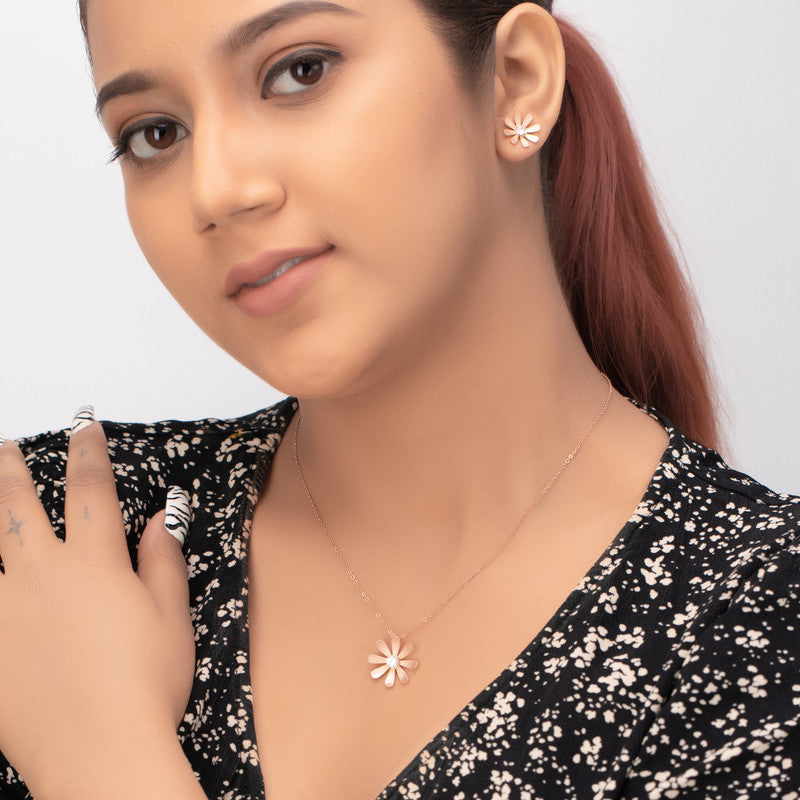 Woman wearing silver tiny daisy pendant set, elegant jewellery for festivals and parties.