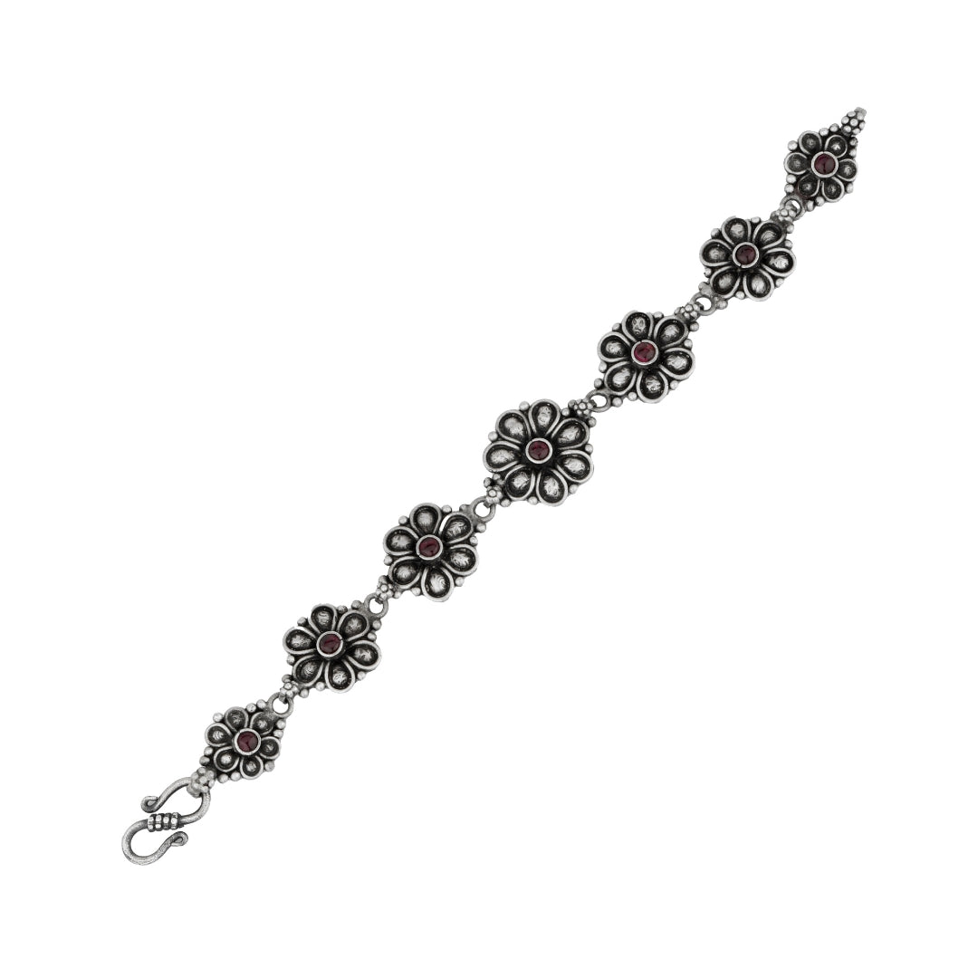 Close-up of antique silver petal design bracelet with detailed petal motifs.