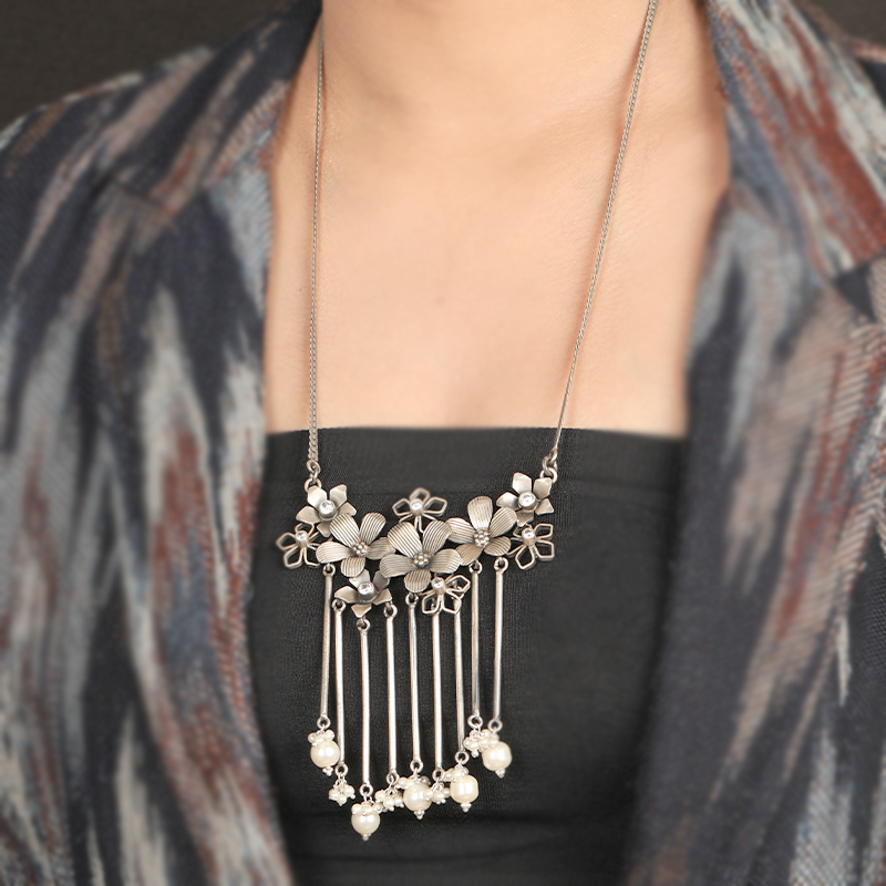 Antique silver flower tassel necklace styled with saree for Navratri, Diwali, and bridal looks