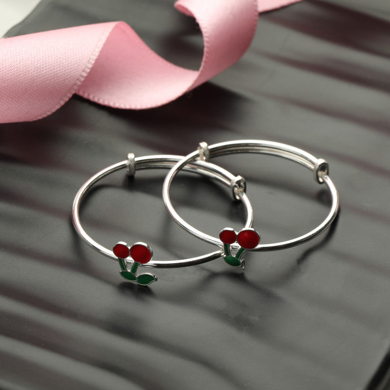 Kids Silver Cherry Kada with Cherry Charm styled on fabric background