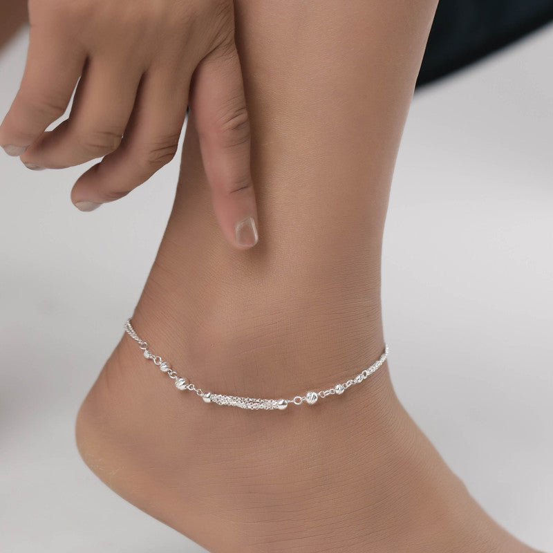 Woman styled in layered mirror ball anklet, elegant jewellery for Navratri wear and festive occasions.