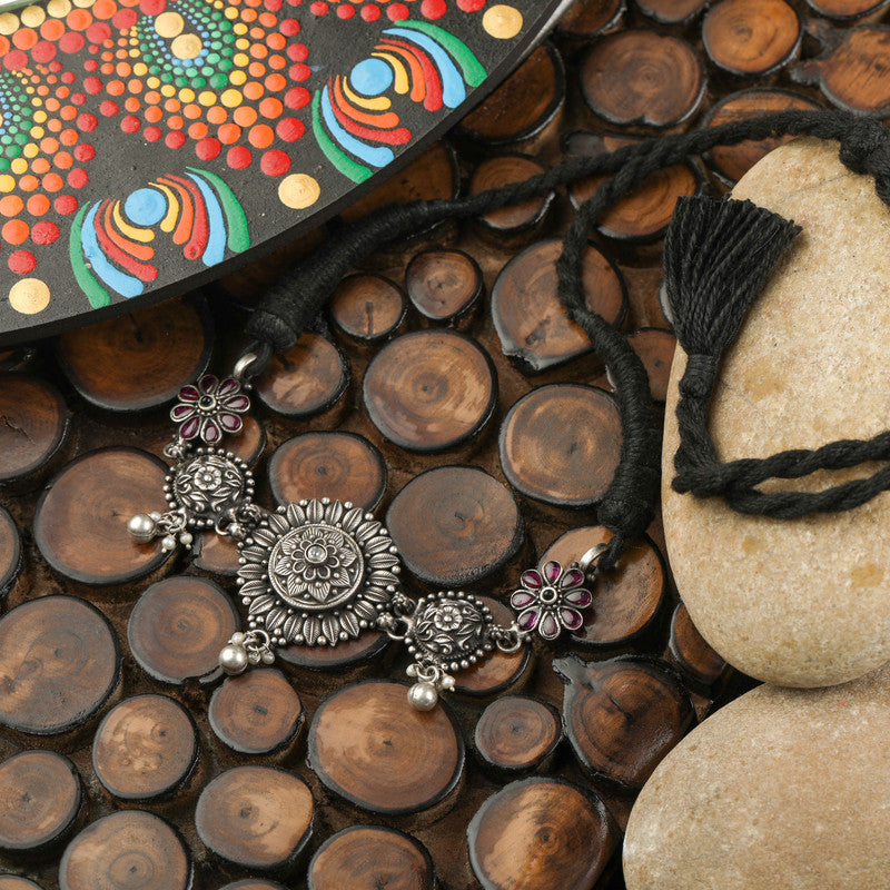 Detailed view of beads and floral motifs on oxidised silver choker necklace, traditional Indian jewelry, festive accessory design, ethnic ornament details