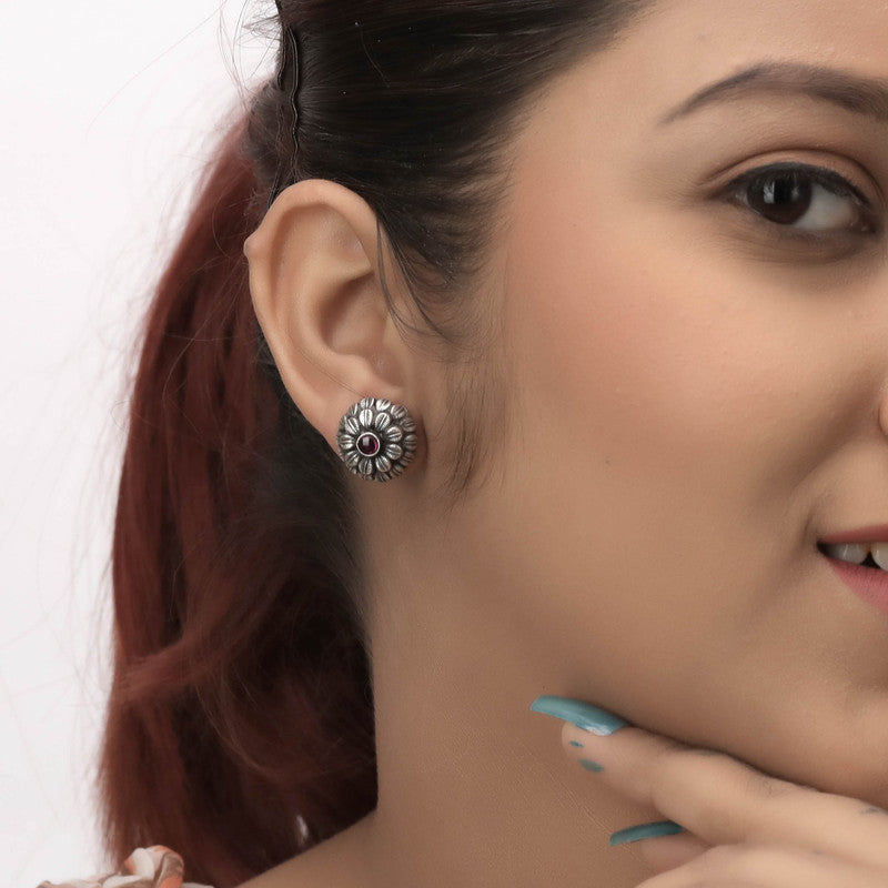 Elegant oxidized silver floral stud earrings on model – stylish ethnic jewelry for weddings and cultural celebrations