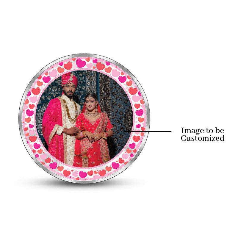 Round 999 pure silver personalized wedding coin featuring couple photo in pink decorative frame.