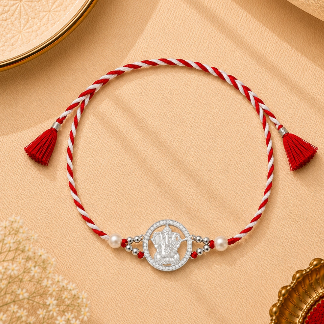 Silver Lord Ganpati Rakhi with Stone placed with roli chawal and festive decor – premium 925 silver Raksha Bandhan gift by Silviya.