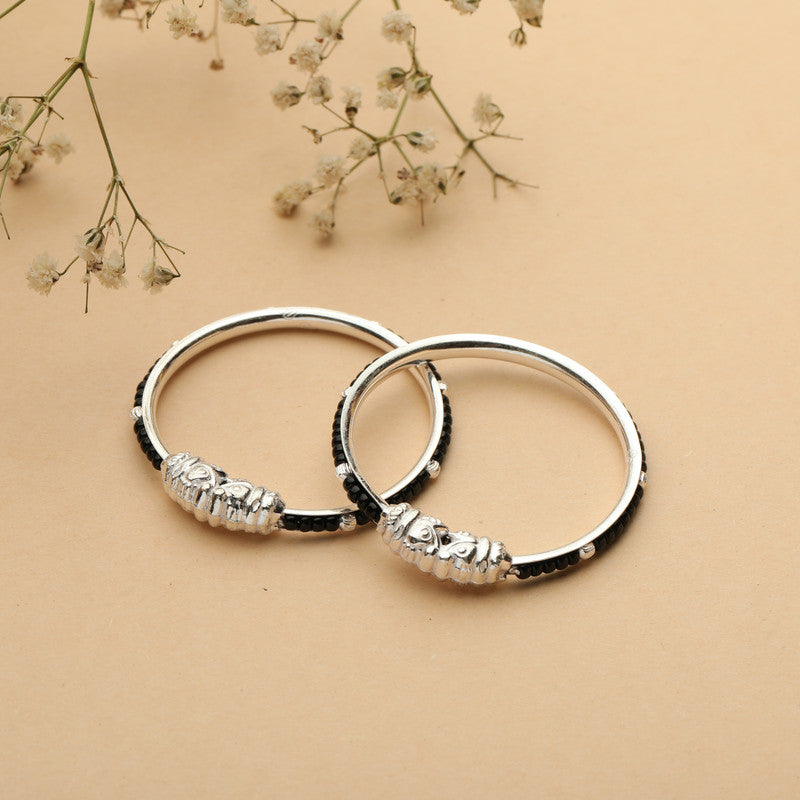 Kids' Silver Nazariya Kada with Black Beads styled on fabric background