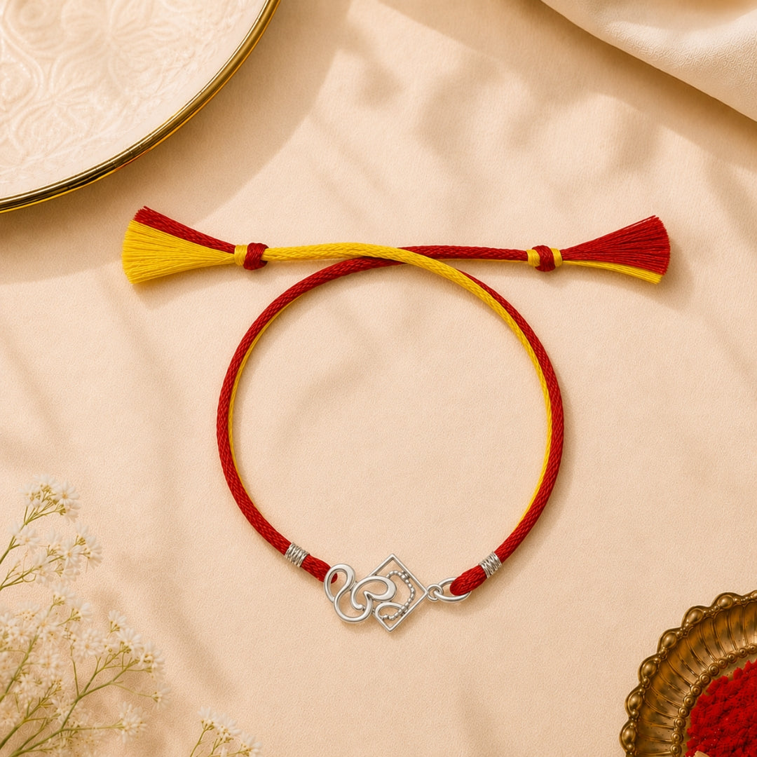 Silver Om Cum Pendant Rakhi placed with roli chawal and festive decor – premium 925 silver Raksha Bandhan gift by Silviya.