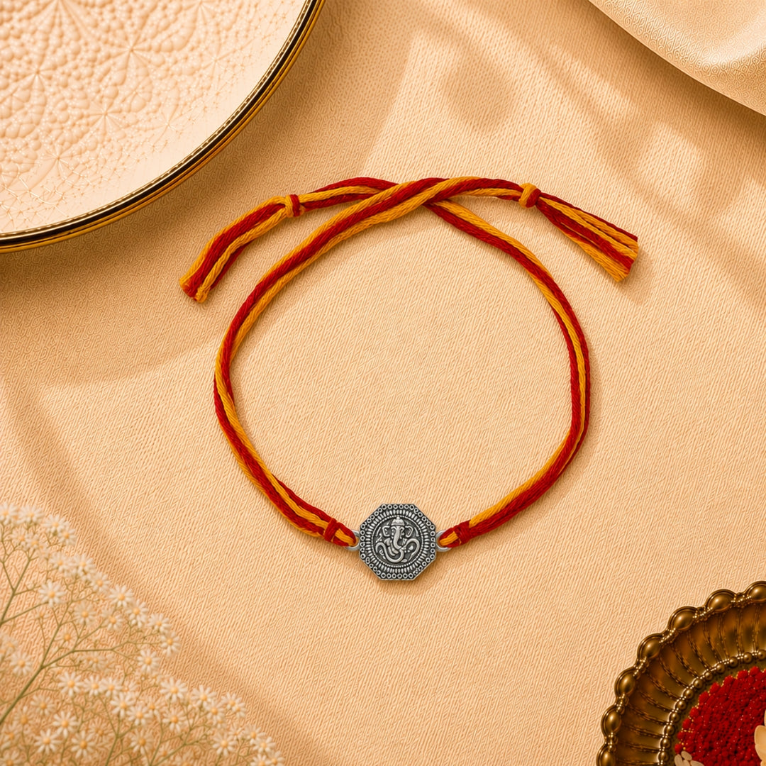Silver Om Ganesha Rakhi placed with roli chawal and festive decor – premium 925 silver Raksha Bandhan gift by Silviya.