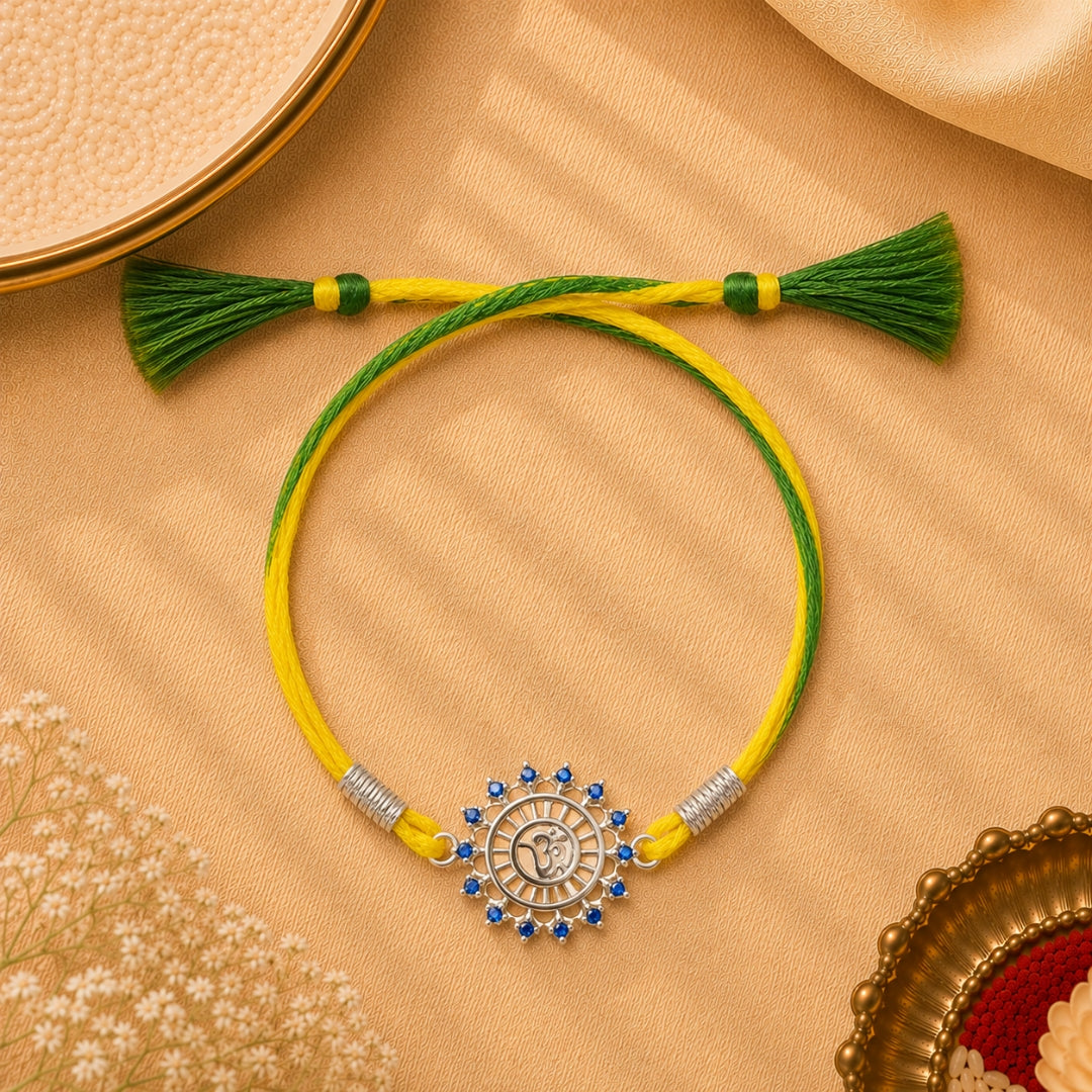 Silver Om Sun Rakhi placed with roli chawal and festive decor – premium 925 silver Raksha Bandhan gift by Silviya.