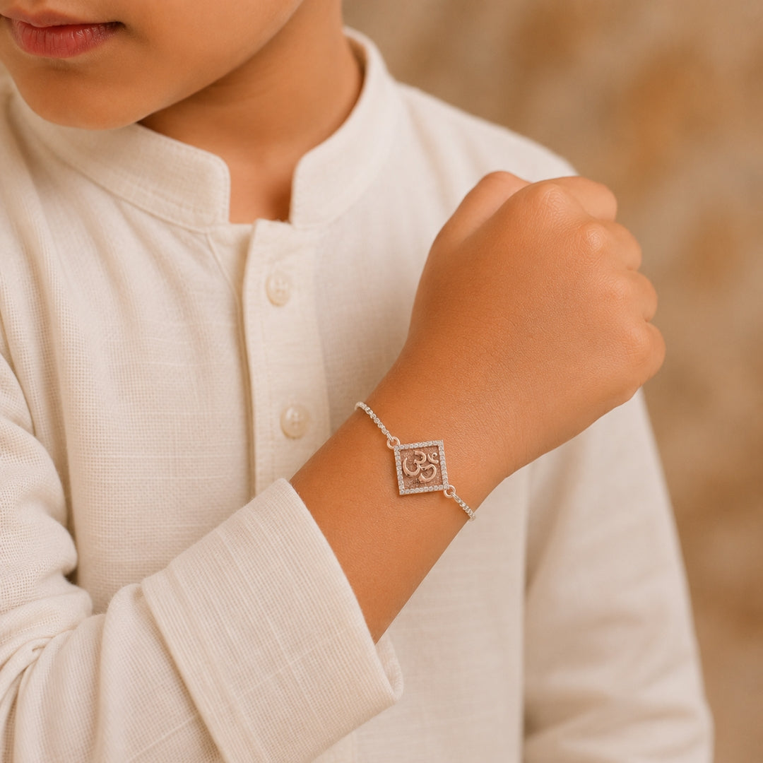 Sterling Silver Om Rakhi Bracelet for Kids placed with roli chawal and festive decor – premium 925 silver kids Raksha Bandhan gift by Silviya.