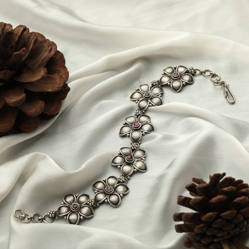 Traditional oxidized silver Pankhudi bracelet displayed on fabric.