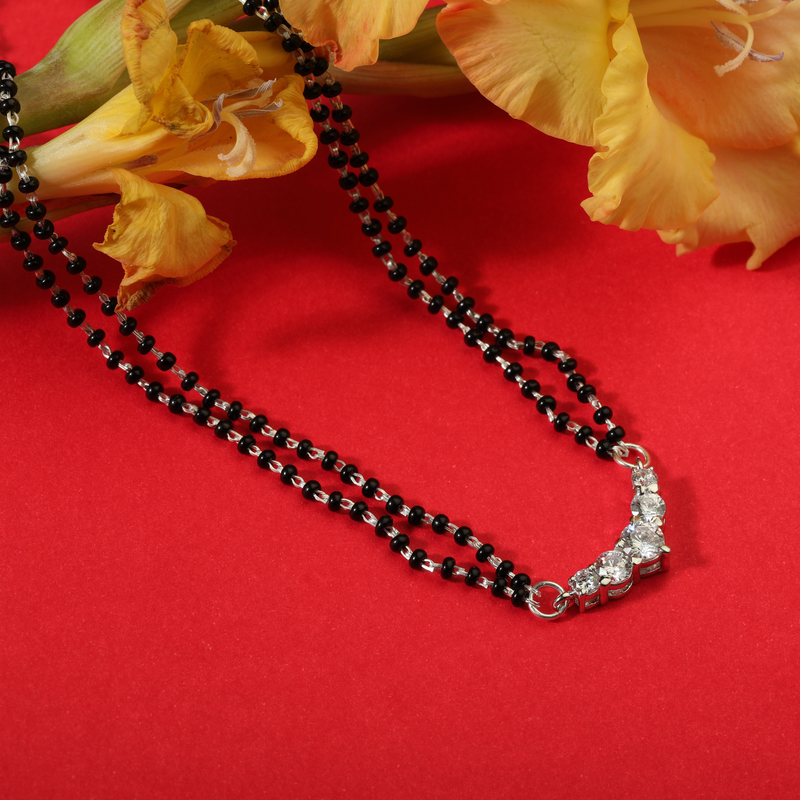 925 Silver Eternal Knot Mangalsutra displayed on festive background – traditional silver jewellery with graceful design.