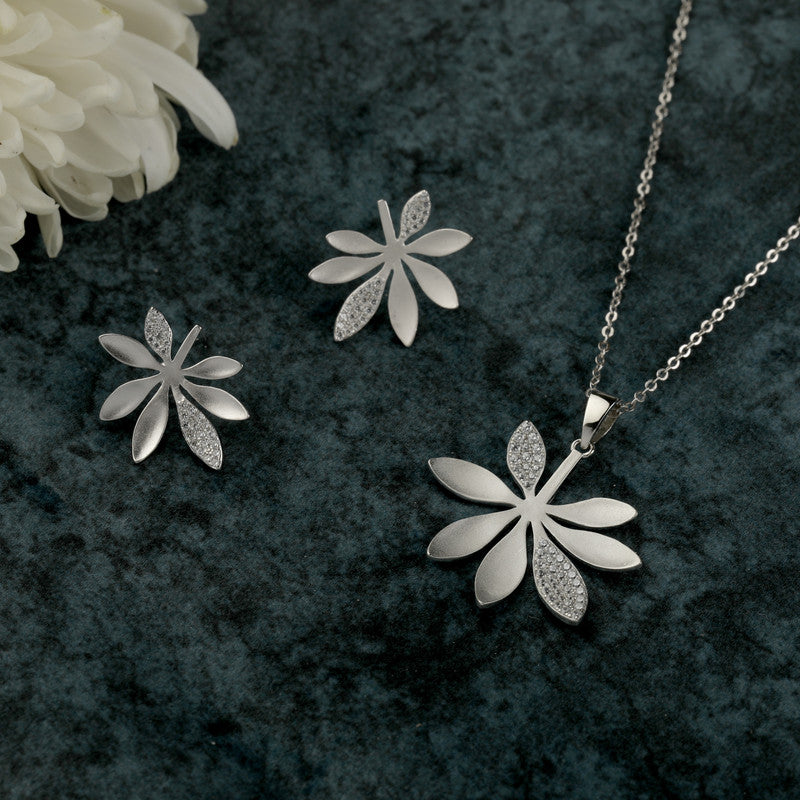 925 silver floral pendant and earrings placed on wooden surface – traditional silver accessory set