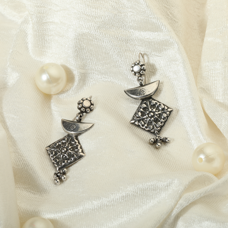 925 Silver Geometric Earrings displayed as prop image on festive background – trendy silver earrings with fine detailing.