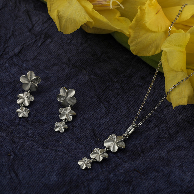 925 silver hanging flower earrings placed on wooden surface – traditional silver accessory