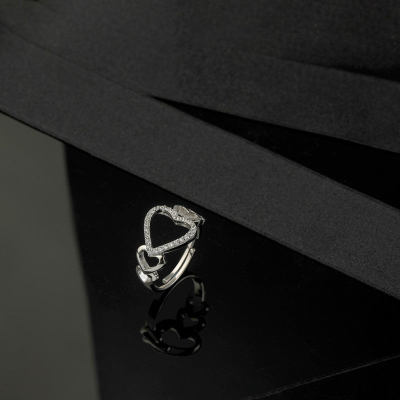 925 silver hollow heart ring displayed with props – romantic silver accessory