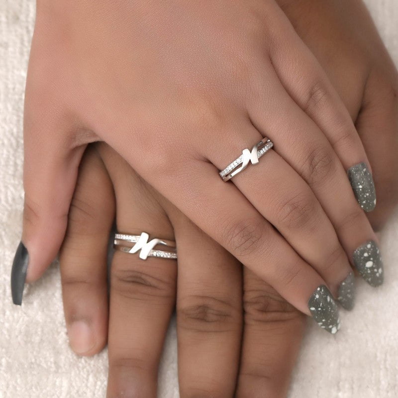 Man and woman wearing 925 silver initial couple rings – stylish matching jewelry set