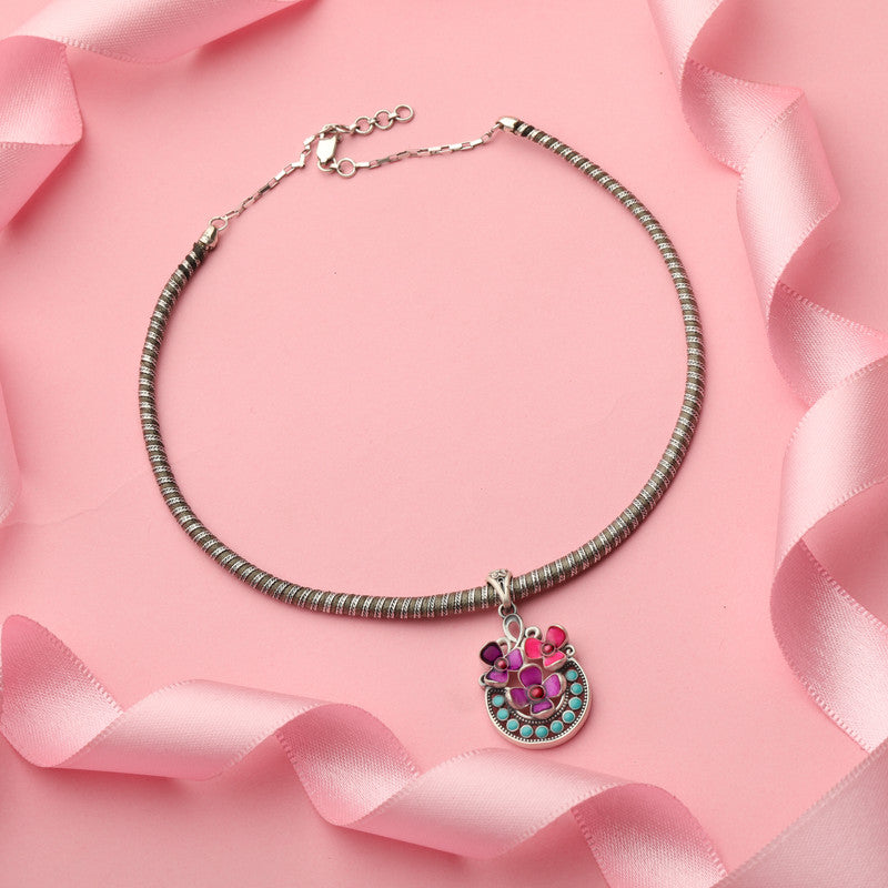 Close-up of 925 Silver Pink Floral Pendant Necklace placed on dark fabric surface
