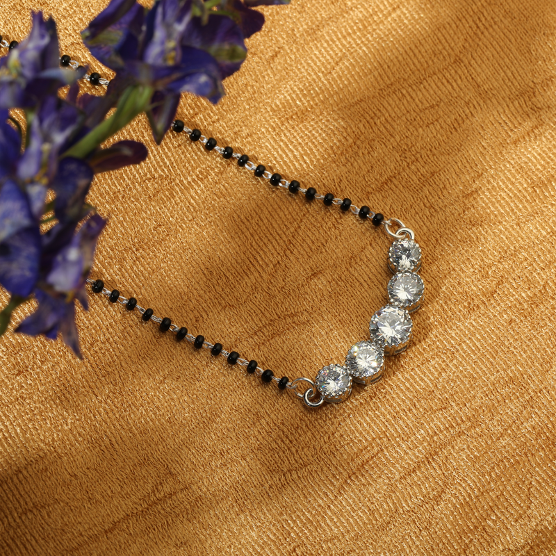 925 Silver Sacred Vow Mangalsutra displayed on red festive background – modern yet traditional silver mangalsutra jewelry.