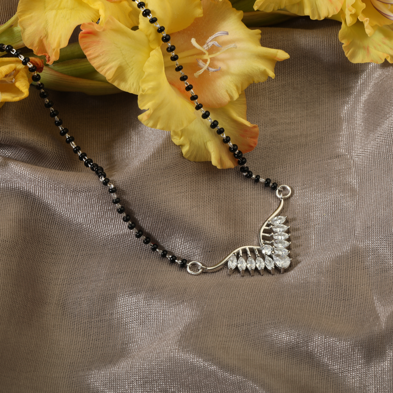 925 Silver Soulmates Mangalsutra displayed on red festive background – modern silver jewelry for gifting.