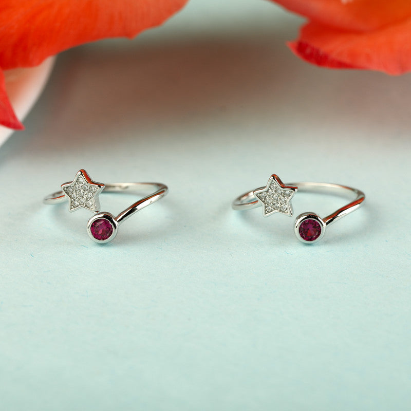 925 silver star and pink gemstone toe ring displayed with props – celestial silver accessory with gemstone