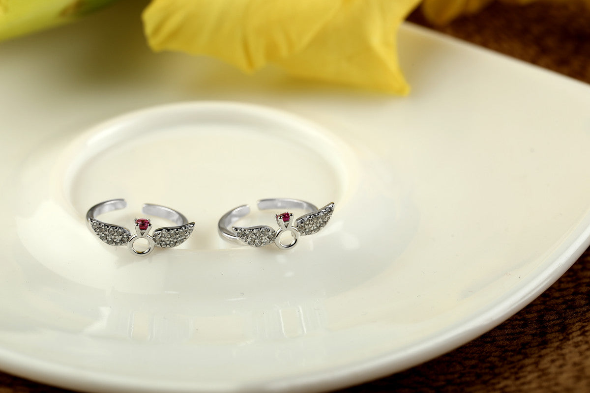 925 silver winged heart toe ring displayed with props – romantic silver accessory