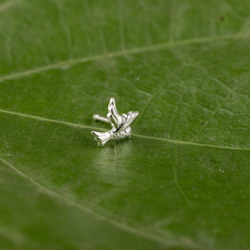 Close-up of 925 Sterling Silver Bird Nose Pin placed on green surface