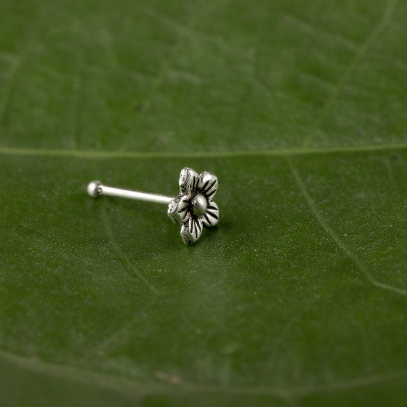 Close-up of 925 Sterling Silver Floral Nose Pin placed on dark fabric surface
