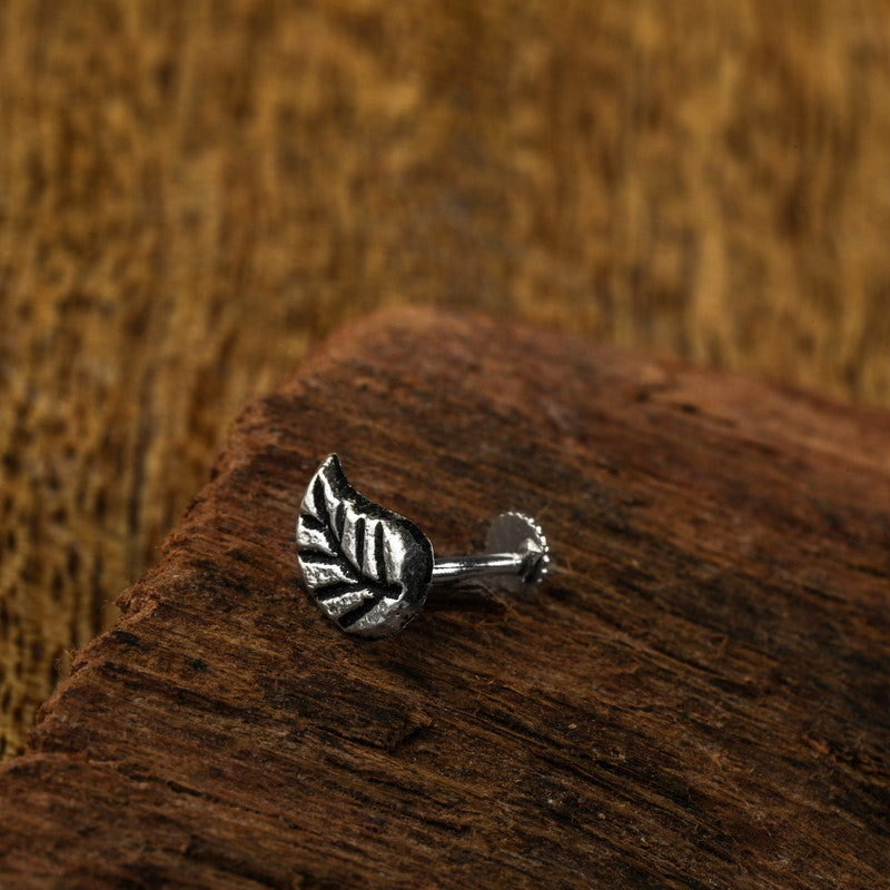 Close-up of 925 Sterling Silver Leaf Nose Pin placed on dark fabric surface