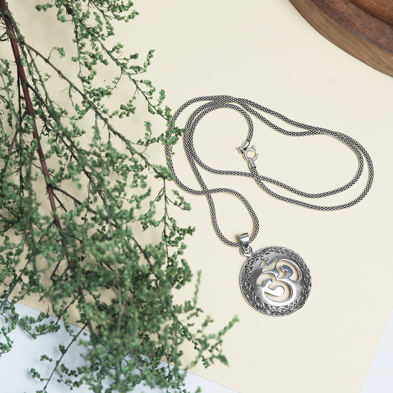Men’s 925 Sterling Silver Om Pendant with Detailed Spiritual Design displayed on surface